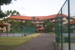 A wing of the hotel and the tennis courts